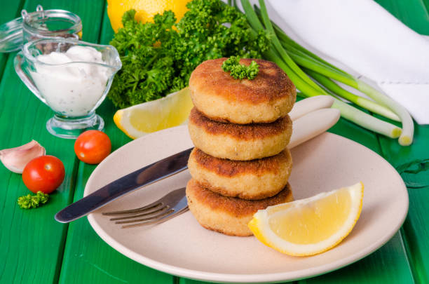 istock Stack of fish cutlets with fresh parsley and green onions 1264876081