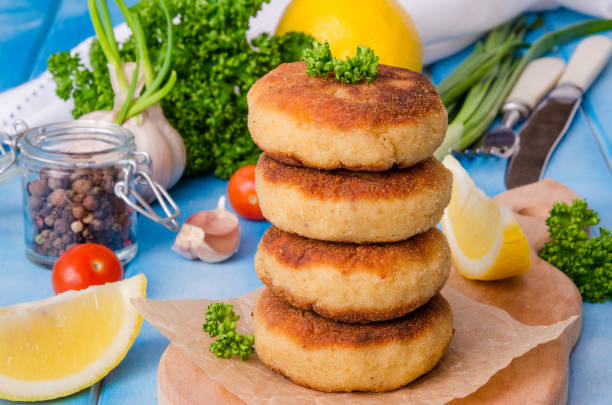 istock Stack of fish cutlets with fresh parsley and green onions 1264876085