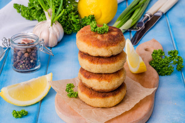 istock Stack of fish cutlets with fresh parsley and green onions 1264876086