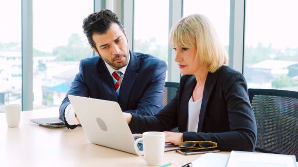 istock Two business people talk project strategy at office 1264876979