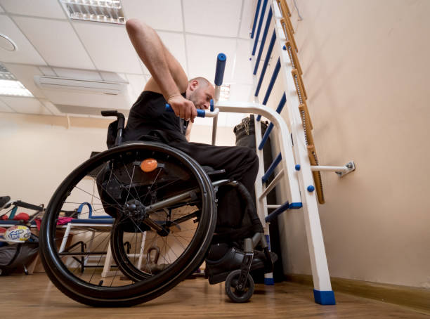istock Disabled man training in the gym. Rehabilitation center 1264877054