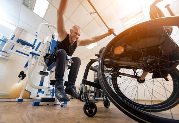istock Disabled man doing strength exercises separate from the wheelchair. 1264877107