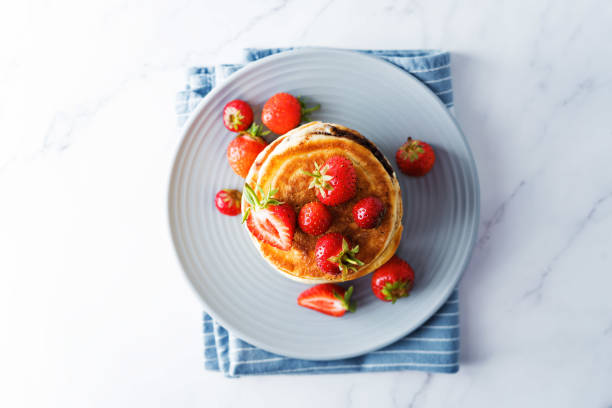 istock Pancakes with chocolate nutella filling decorated with strawberries 1264879436