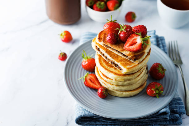 istock Pancakes with chocolate nutella filling decorated with strawberries 1264879462