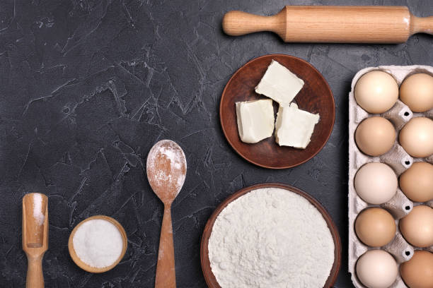 istock Eggs and flour and  on a dark background. 1264881279