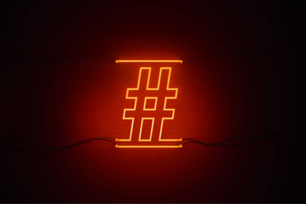 istock Hashtag Symbol Drawn by Red Neon Light on Black Wall - Online Messaging Concept 1264885185