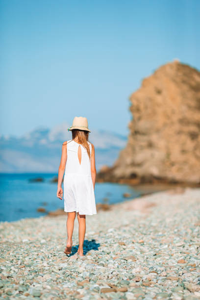 istock Cute little girl at beach during summer vacation 1264889074