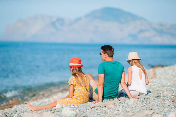 istock Happy beautiful family on a tropical beach vacation 1264890420