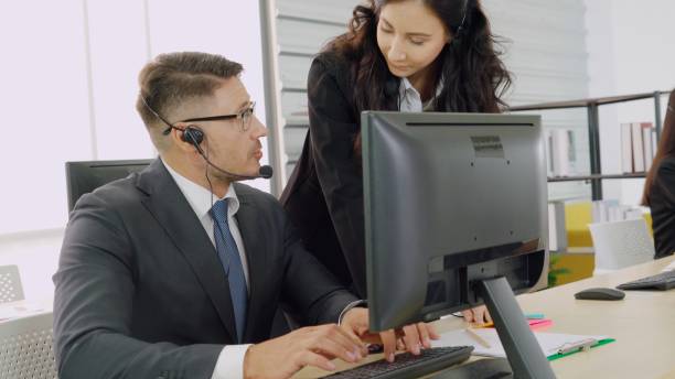 istock Business people wearing headset working in office 1264892948