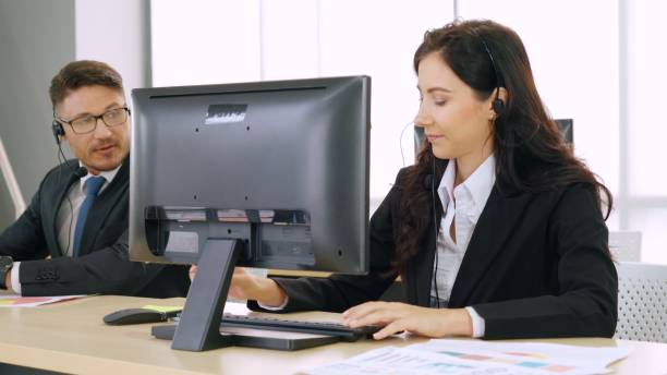 istock Business people wearing headset working in office 1264894676