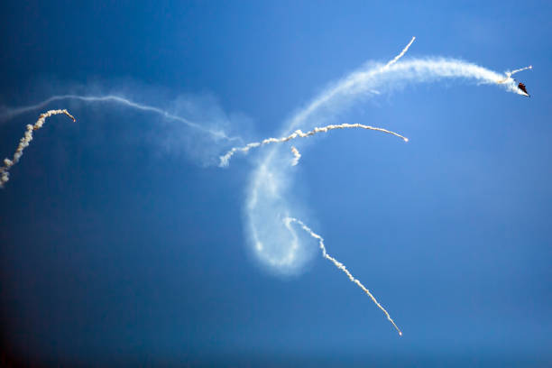 istock Condensation marks on the blue sky from jet planes. 1264894827