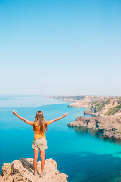 istock Kid on vacation on white rock background 1264897029