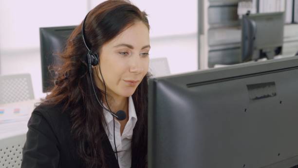 istock Business people wearing headset working in office 1264897614