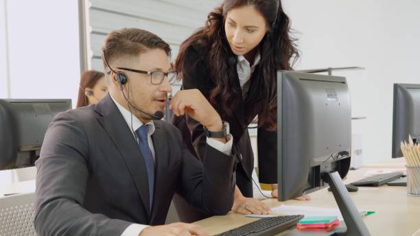 istock Business people wearing headset working in office 1264897853