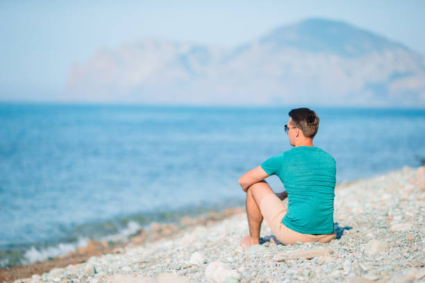 istock Young man on the white beach on vacation 1264900504