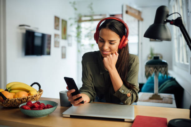 istock Happy young mixed race woman using a smart phone 1264900527