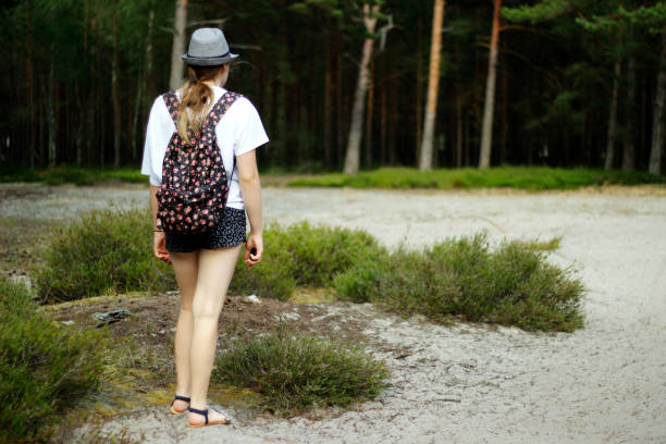istock Girl walking in the forest. 1264907635