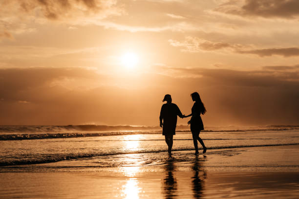 istock Attractive man and woman enjoying romantic evening on sunset 1264915263
