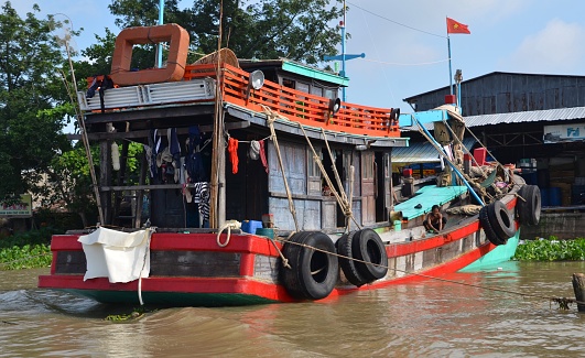 Fishing and house boat on Mekong River in Cambodia with washing on the line.
