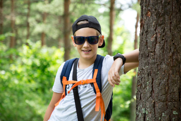 istock Young school boy during hiking in summer pine forest. 1264919682
