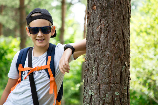 istock Young school boy during hiking in summer pine forest. 1264919688