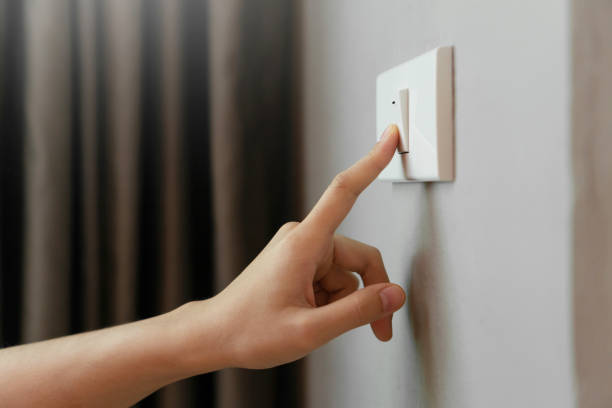 Female finger is turn off on lighting switch Close up of Female finger is turn off on lighting switch at home. Power, Energy, Saving Electrical, Copy space. turning on or off photos stock pictures, royalty-free photos & images