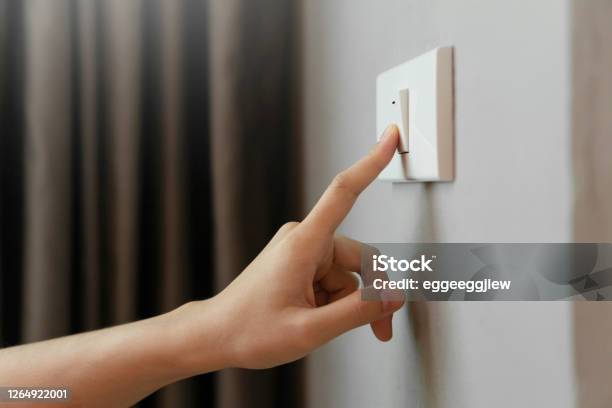Female Finger Is Turn Off On Lighting Switch Stock Photo - Download Image Now - Lighting Equipment, Turning On Or Off, Switch