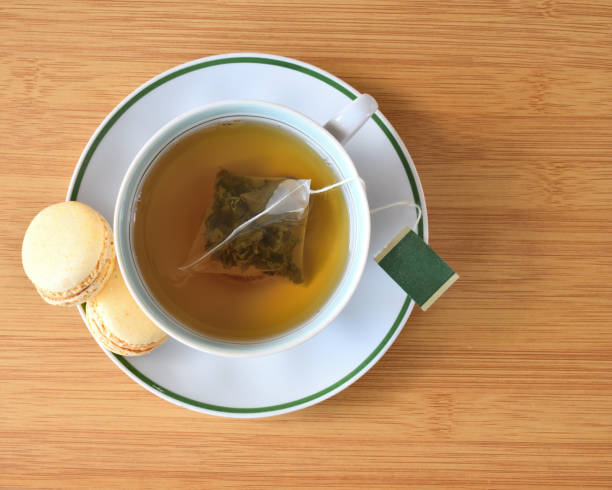 istock Cup of green tea and macaron top view 1264927801