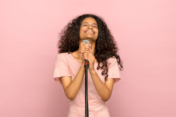 istock Smiling happy young black girl singing 1264932012