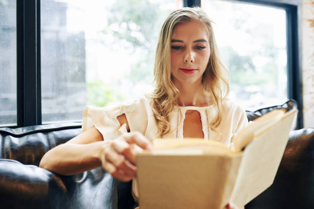 istock Woman reading interesting novel 1264933529