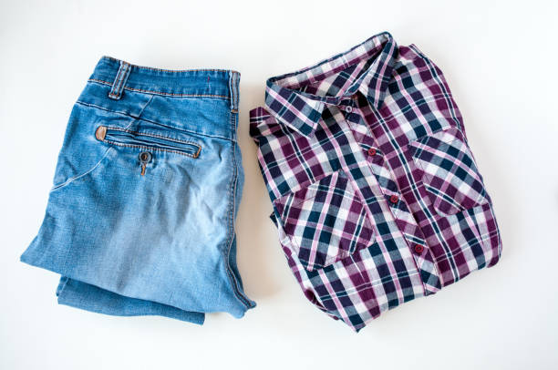 istock Clothing, folded plaid shirt and jeans on a light background 1264933645