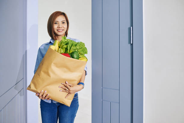istock Housewife with fresh groceries 1264935231
