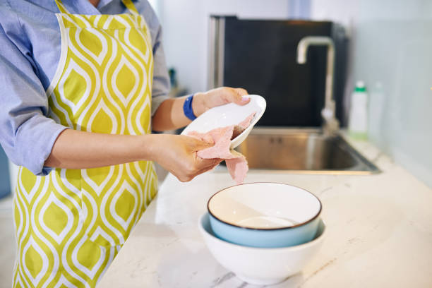 istock Housewife wiping clean dishes 1264935237