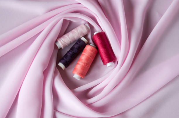 istock Sewing reinforced threads of different colors on pink fabric 1264935307