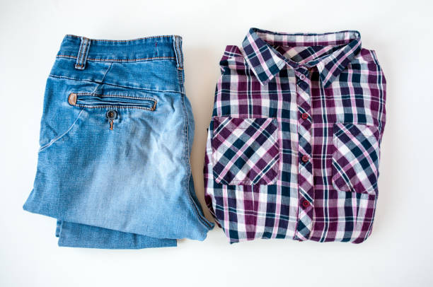istock Clothing, folded plaid shirt and jeans on a light background 1264936034