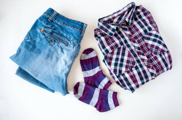istock Clothing, folded plaid shirt and jeans, striped socks on a light background 1264936218