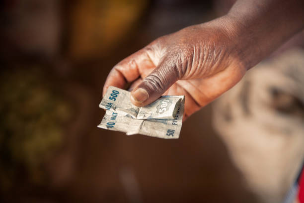 istock Hand holding Rwandan money 1264936262