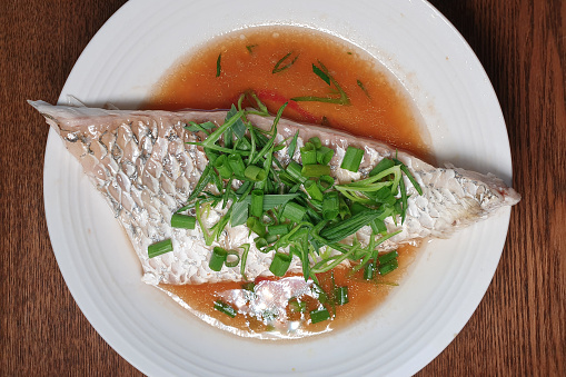Asian, Chinese Style steamed fish with soy sauce and scallion.