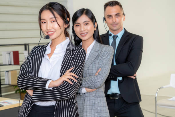 istock Business people wearing headset working in office 1264941799