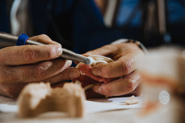 istock A dental technician processes a cast of the jaw 1264943046