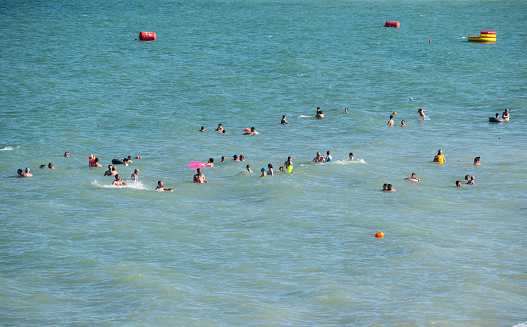 Tourists who come to the sea feel good in the waves of the sea. Romania, Mamaia. July, 28, 2020