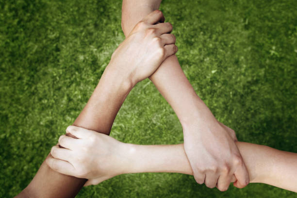 istock Children forming triangle by holding arms 1264949183