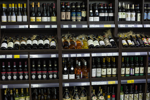 White  wine in center surrounded with red wines bottles (Click for more)