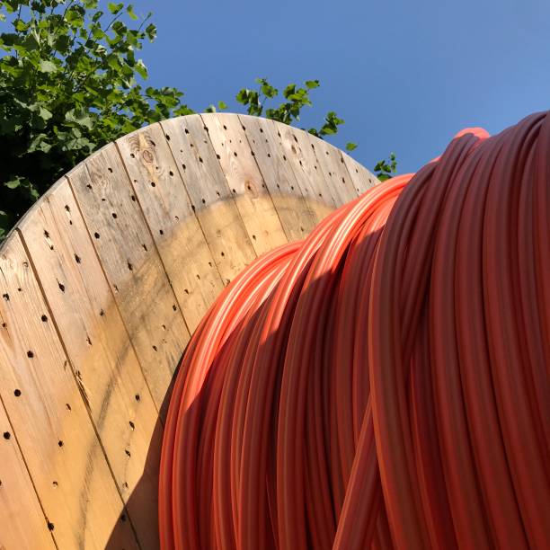 istock Big cable drum with orange cables seen against blue sky 1264956367