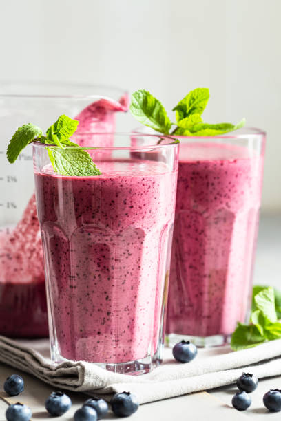 istock Two glasses of blueberry smoothie. 1264956534