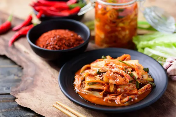 Korean food, Kimchi cabbage with ingredients on wooden table