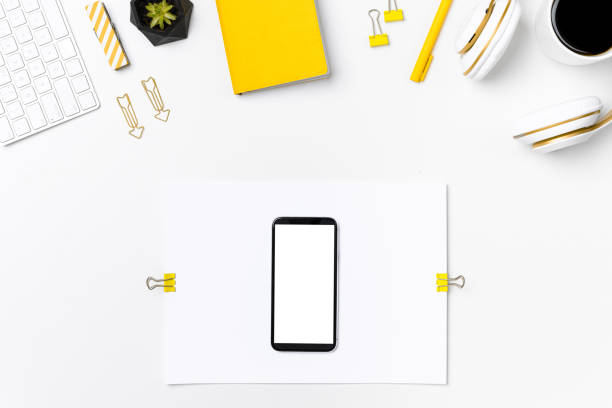 istock Mobile phone on designer workplace mockup top view 1264957537