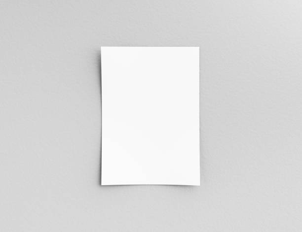istock Hanging paper or pasteboard on a white wall for Information, display or schedule. 3D Illustration. 1264957644