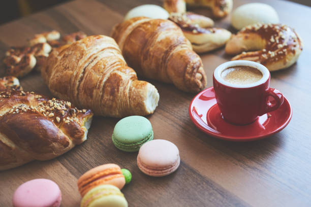 croissant, cake, espresso, macaron on wood