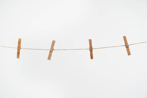 istock Wooden clothespins on rope on white background. 1264961072